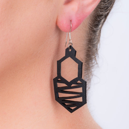 Honeycomb recycled rubber earrings worn on model