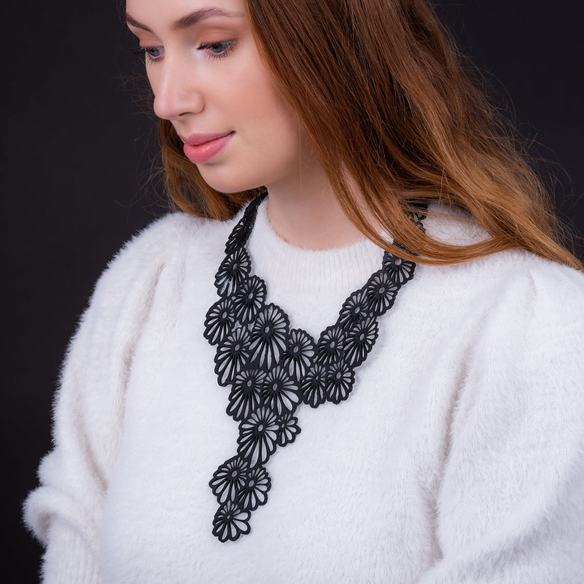 Daisy black floral recycled rubber necklace worn on model